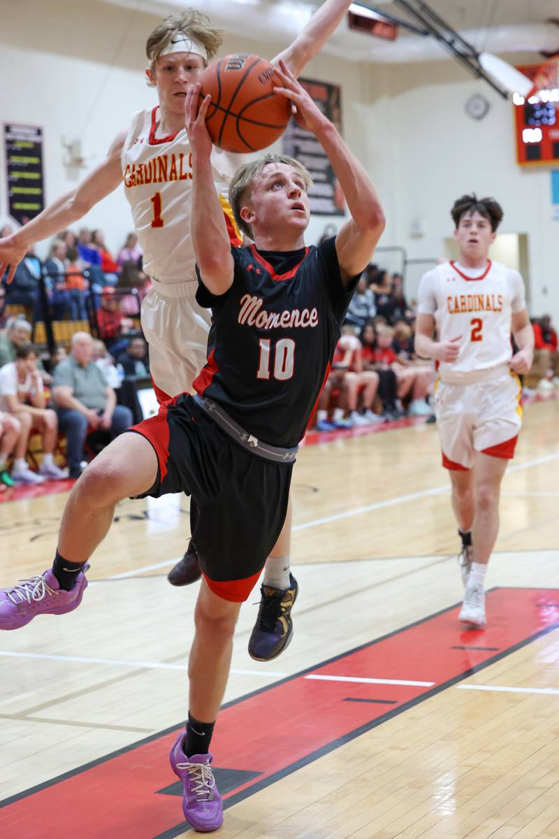 Momence's  Sam Fitzgerald goes for a layup under pressure from St. Anne's Raleigh Hays during St. Anne's 64-43 victory in the River Valley Conference semifinals on Tuesday, Feb. 10, 2026.