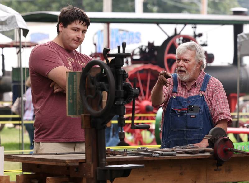Will Slagel, (right) from Woodstock, talks about some of his vintage tools with Austin Morris, from Sandwich, Wednesday, Sept. 3, 2025, on opening day of the Sandwich Fair.