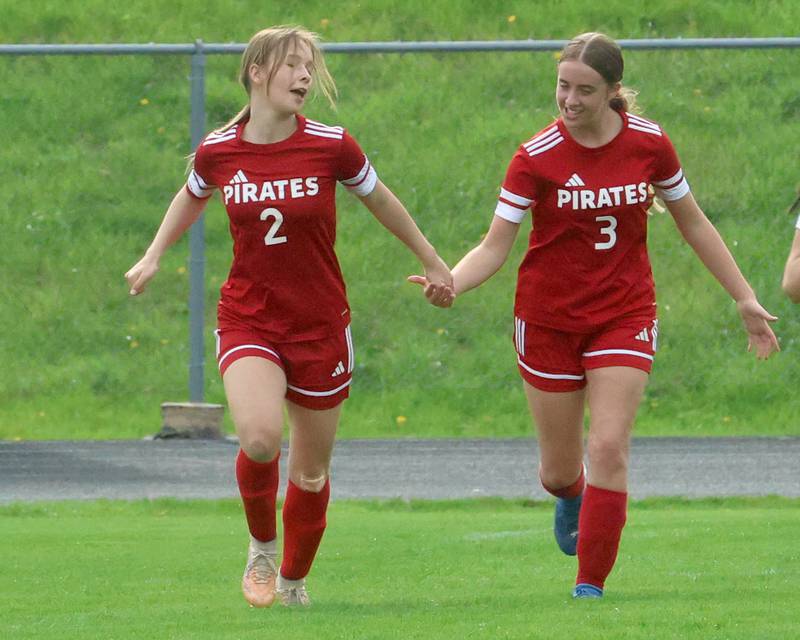Ottawa's Allison Power hi-fives teammate Chloe Carmona after scoring a goal against L-P on Monday, April 13, 2026 on King Field at Ottawa High School.