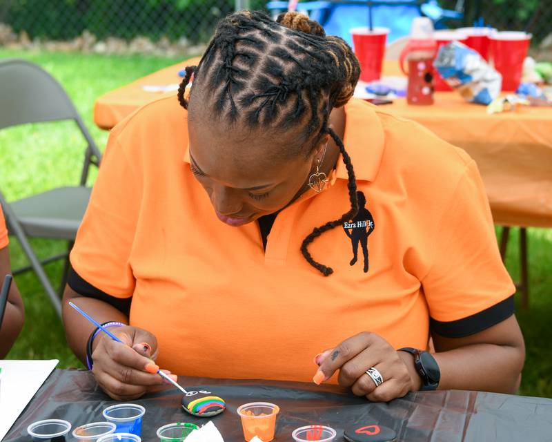 Andrea Elion, mother of the late Ezra Hill Jr. 10, of DeKalb, paints a rock on Saturday, June 7, 2025, during the Ezra Hill Jr. Memorial Foundation’s 5th annual rock painting event held at Tyler Elementary School in DeKalb. Elion created the foundation to memorialize her son, shot and killed in 2019, and to spread awareness about gun violence.