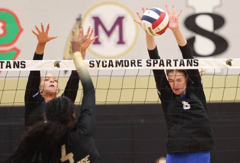 Burlington Central's Ainsley Wilson blocks the spike of Sycamore's Khiara  Thomas Tuesday, Oct. 29, 2024, during their Class 3A regional match at Sycamore High School.