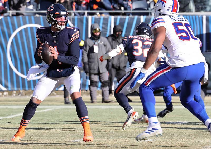 Chicago Bears quarterback Justin Fields looks for a receiver in the Buffalo secondary during their game Sunday, Dec. 24, 2022, at Soldier Field in Chicago.