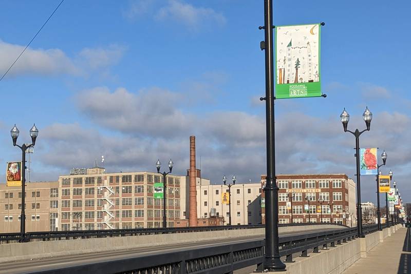 Holiday banners from Woodlawn ArtsAcademy’s summer 2022 “Christmas in July” exhibit along Sterling's First Ave. bridge