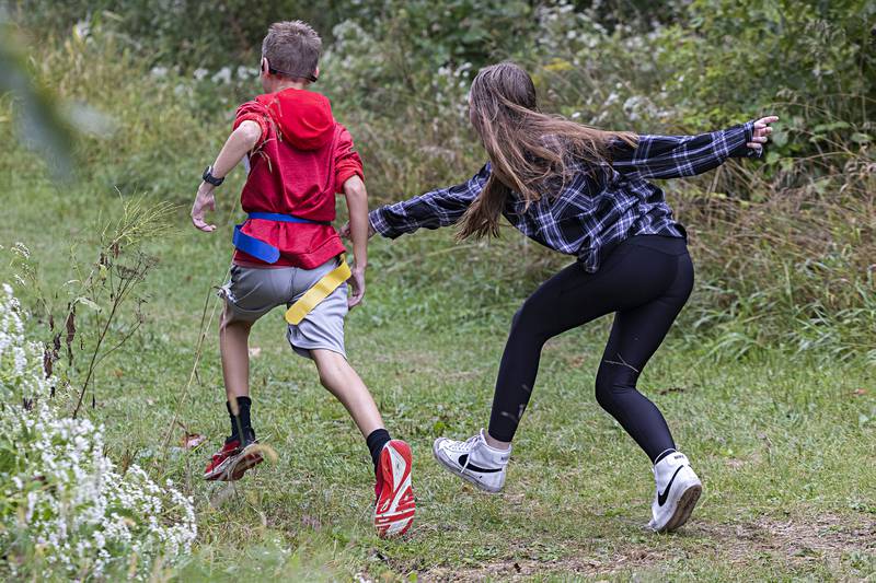 Kendall Como tries to grab Blake Plummer’s flag as he passes through the zombie ambush Saturday, Sept. 16, 2023.