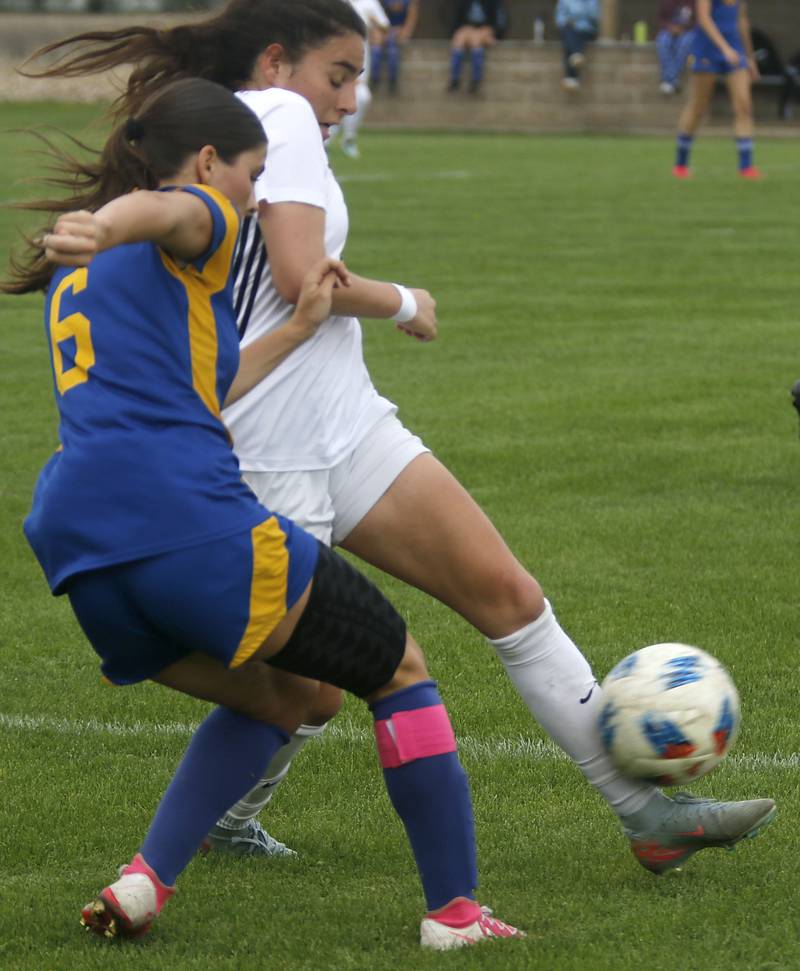 Harvard's Julie Silva kicks the ball away from Johnsburg's Liz Smith during a Kishwaukee River Conference soccer match on Wednesday, April 27, 2026, at Johnsburg High School.