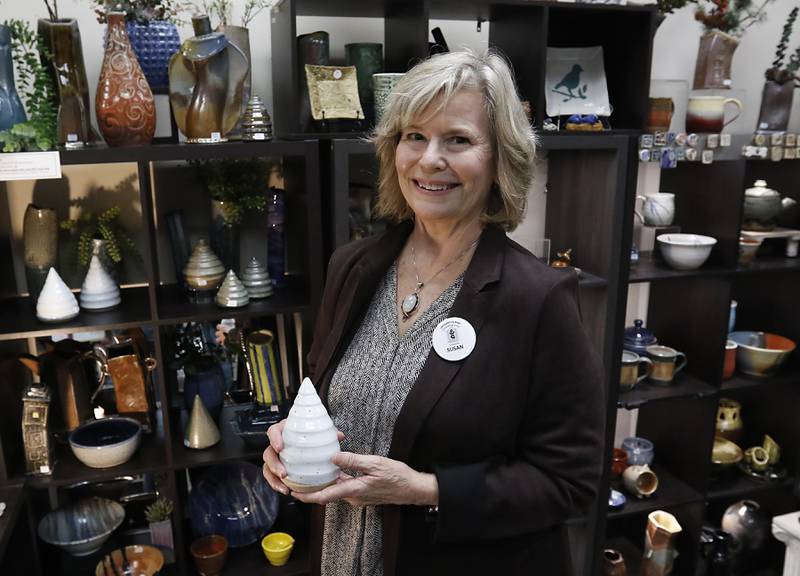 Susan Clough with a holiday tree that she makes on Thursday, Dec. 19, 2024, at Artisans on Main in Woodstock. Several of the artists have holiday themed items for sale.