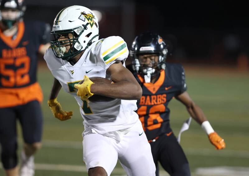 Waubonsie Valley's Tyler Threat carries the ball after catching a pass during their game Friday, Sept. 29, 2023, at DeKalb High School.