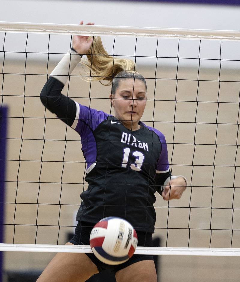 Dixon’s Solis Thompson driops the ball over the net against North Boone Tuesday, Sept. 24, 2024, in Dixon.
