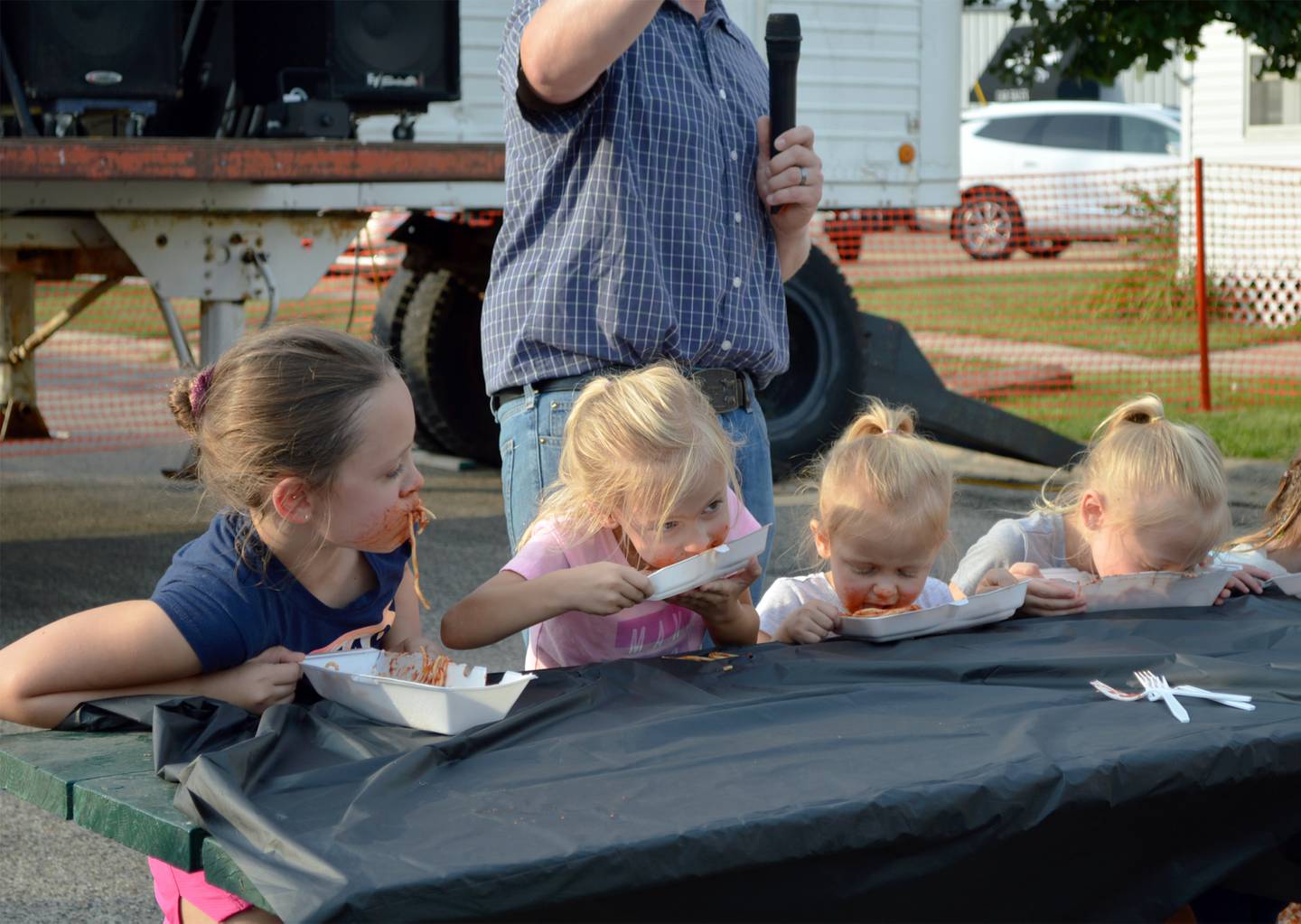 The Sieber sisters — Kennlee, 8; Hadlee, 6; Brenlee, 3; and Onalee, 7 — take part in a spaghetti-eating contest on Friday, Aug. 4, 2023, during the annual Forreston Sauerkraut Days' Family Fun Night.
