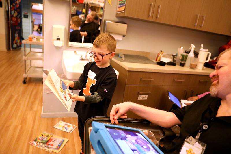 Grace McWayne Elementary School first grader Beckett Korder reads a book to a Marklund Hyde Center client Mike K. on Wednesday, Feb. 5, 2025 in Geneva. First-graders from the Batavia school visited Marklund to make crafts and read books together.