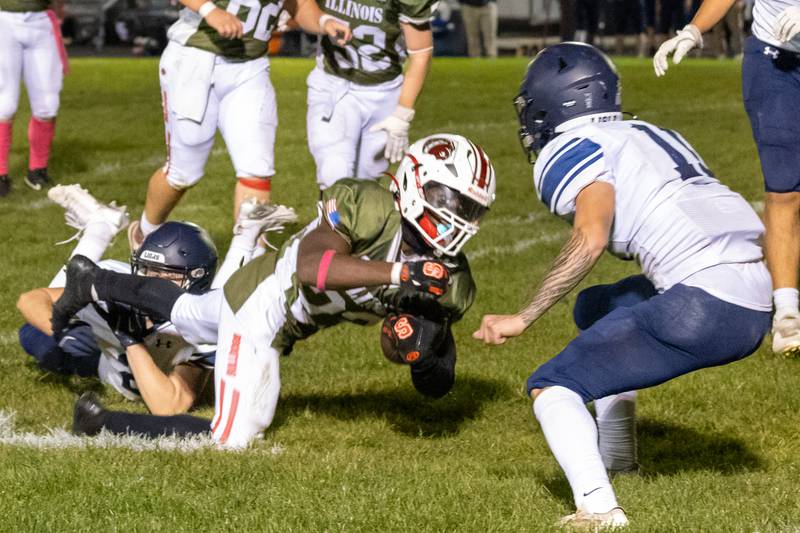 Streator tailback Jordan Lukes runs the ball while being tackled by Lisle defenders Friday, October 4, 2024, at Doug Dieken Stadium in Streator.