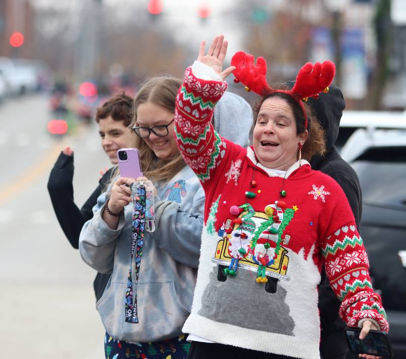 Maryann Racz of McHenry waves to her daughter during the Toys for Tots Parade on Sunday, Nov. 24, 2024, in downtown McHenry.