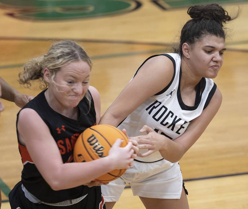 Sandwich’s Bailey Frieders and Rock Falls’ Autumn Weatherby grasp at a ball Tuesday, Nov. 26, 2024, at Rock Falls High School.