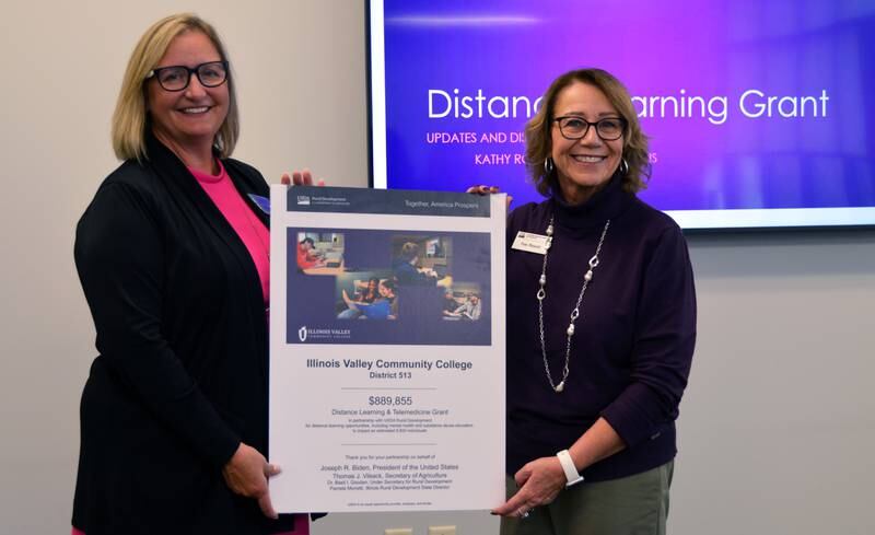 Illinois State Director Pam Monetti presents a recognition of the $899,855 U.S. Department of Agriculture Rural Development grant to Illinois Valley Community College President Tracy Morris. The grant allowed the purchase of technology for distance learning classrooms that will launch exciting opportunities for area high school students. After viewing one of the classrooms, the representatives joined Morris on a campus tour.