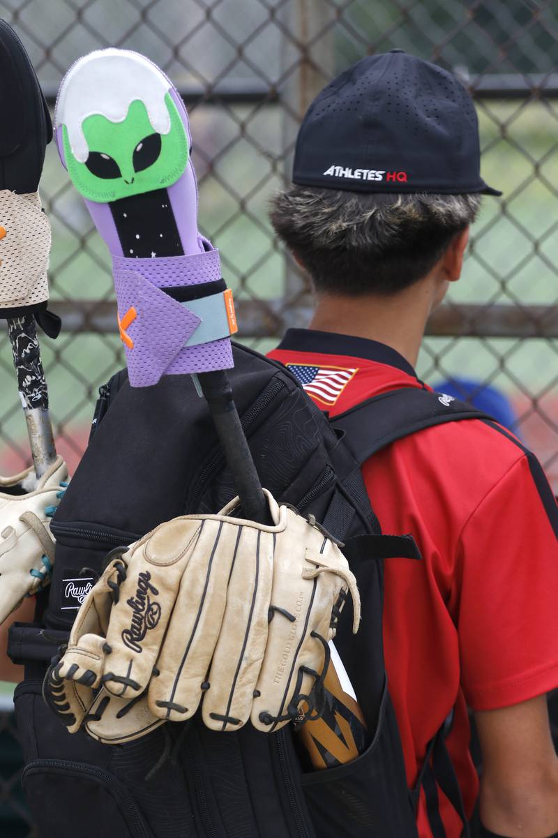 Noah Garcia from the AHQ baseball team warts a game with his “alien sliding mitt” over his bat, during the opening round of the Under 13 McHenry County Youth Sports Association’s Summer International Championship baseball tournament on Friday, July 11, 2025, at the Mickey Sund Baseball Complex in Crystal Lake's Lippold Park.