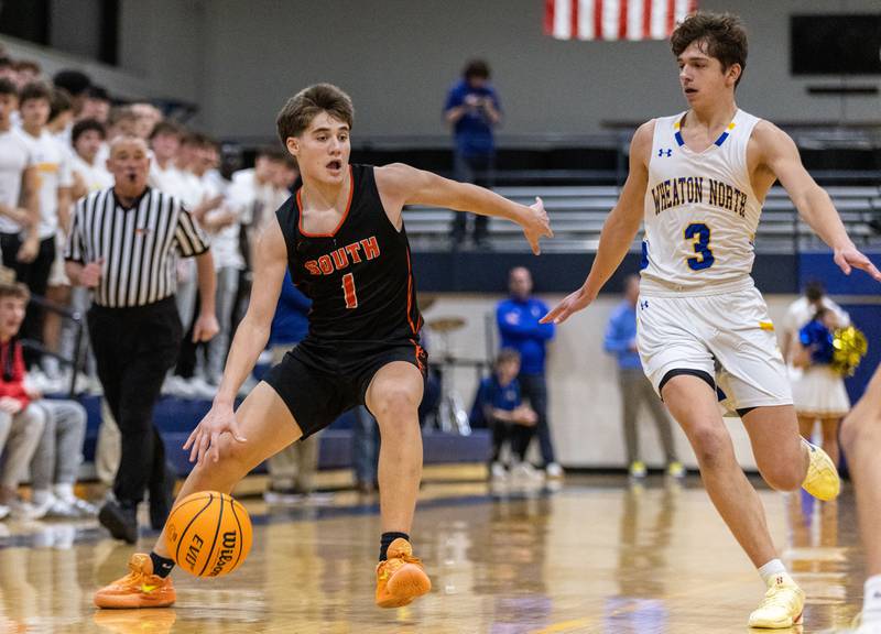 Wheaton Warrenville South’s Brady McClatchy drives the lane during a game against Wheaton North on Friday, Dec. 20, 2024.