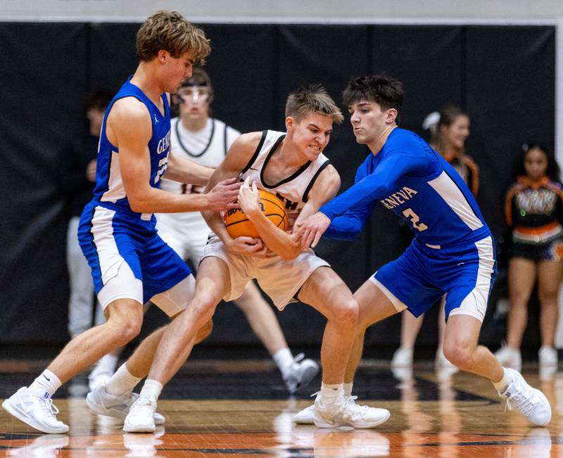Wheaton Warrenville South’s Braden Triscik attempts to keep the ball away from Geneva defenders during a game at Wheaton Warrenville South High School on Tuesday, Dec. 3, 2024.