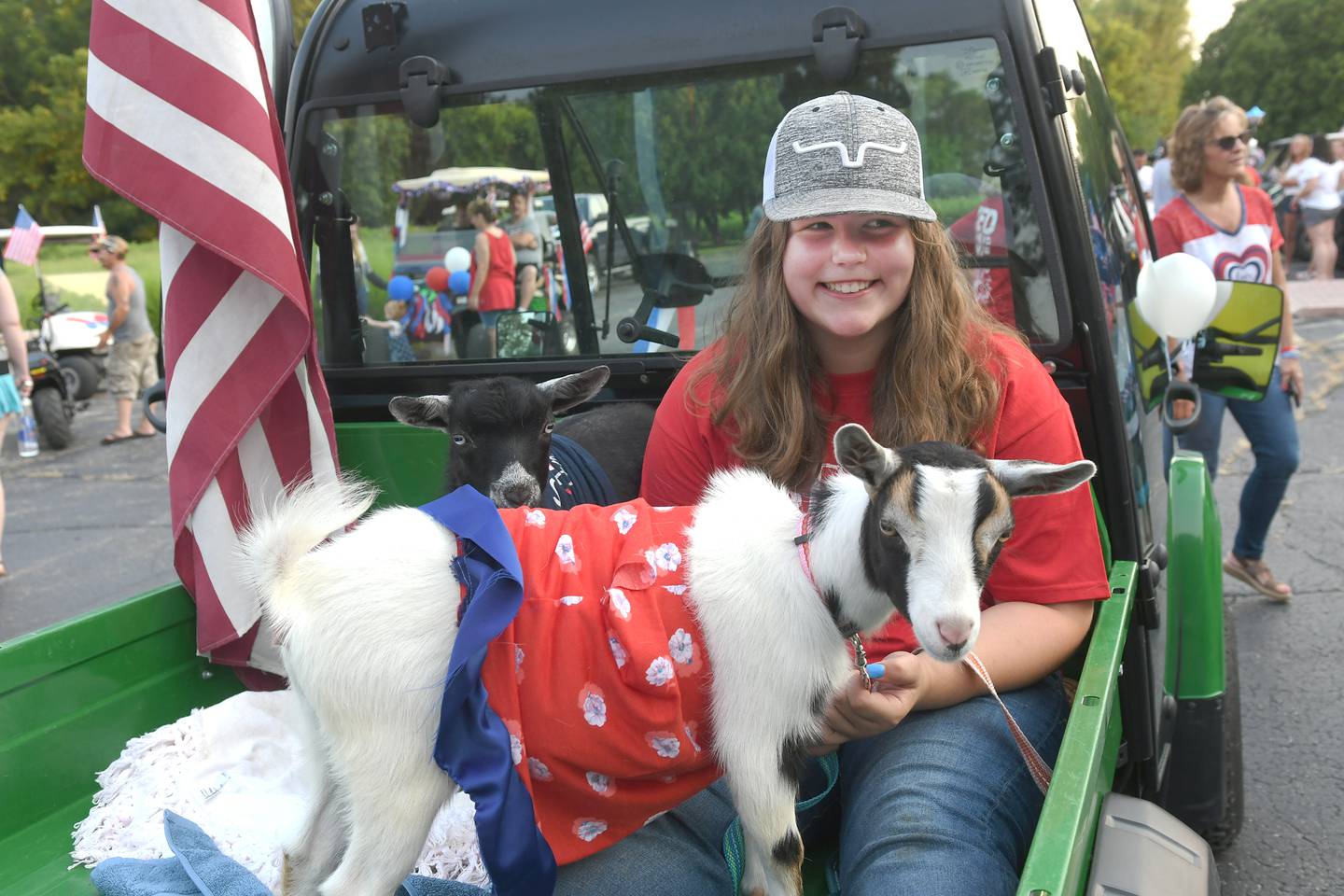 Jacklyn Heller rode in the back of her family's John Deere ATV gator with her two "kids" Deliah and Zion.