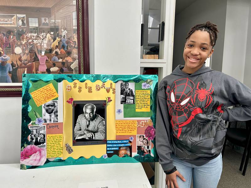 Zoey Hollins stands next to her poster board detailing the life of actor Ossie Davis on Sunday, Feb. 16, 2025, at New Hope Missionary Baptist Church in DeKalb. The presentation was part of the church's annual Black History Month event "Displays of Excellence.”