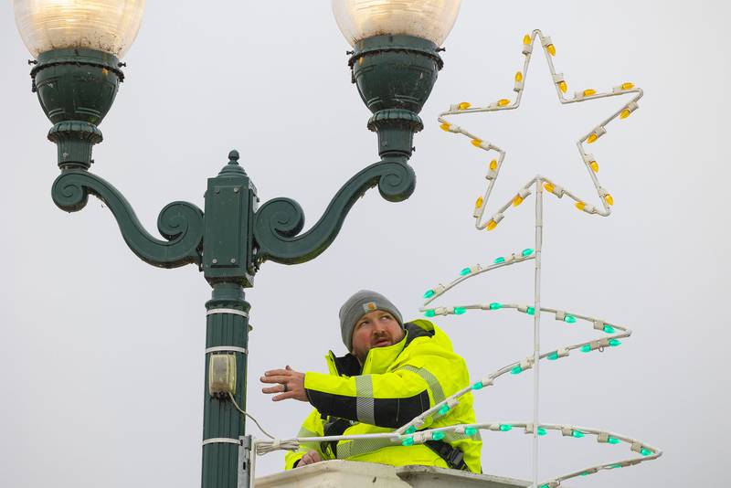 Everett Dearing checks the lights on a holiday display he is putting up along the Galena Avenue bridge in Dixon Tuesday, Nov. 15, 2022.