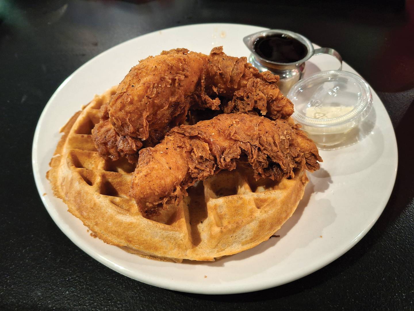 Chicken and waffles, a classic southern pairing, is one of the entree options at Reid's Southern Kitchen and Smokehouse in Peru.