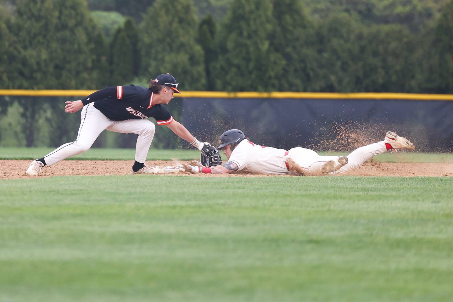 Lincoln-Way Central’s Collin Mowry steals second ahead of the tag by Lincoln-Way West’s Tyler Koscinski on Monday, May 8, 2023 in New Lenox.