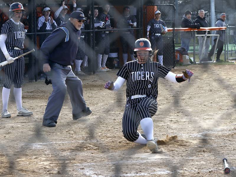 Crystal Lake Central's Harper Wright slides into home to score a run during a Fox Valley Conference softball game against Huntley on April 7, 2026, at Crystal Lake Central High School.