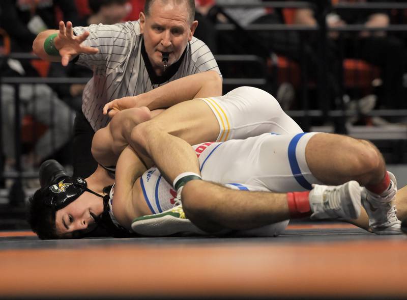 Fremd’s Evan Gosz wrestles Marmion’s Zach Stewart in the Class 3A 144-pound final at the IHSA boys state wrestling championships at the State Farm Center in Champaign on Saturday, Feb. 22, 2025.