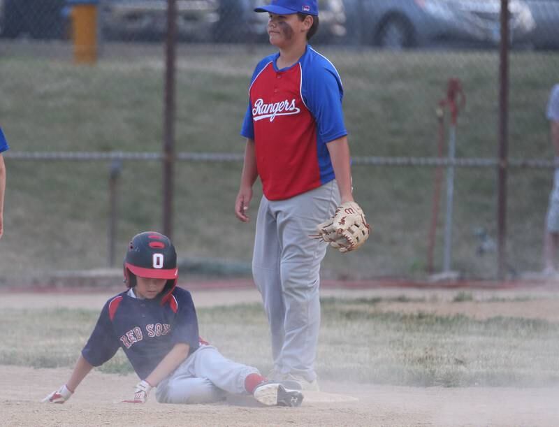 Thrush Sanatation Red Sox's Nick Thrush slides in safely to second base on a pass ball as Frostbyte MSP Rangers Bryce Ceja watches the throw go into the outfield in the Ottawa Little League baseball (12U) City Championship on Friday, June 23, 2023 at Varland Park in Ottawa.