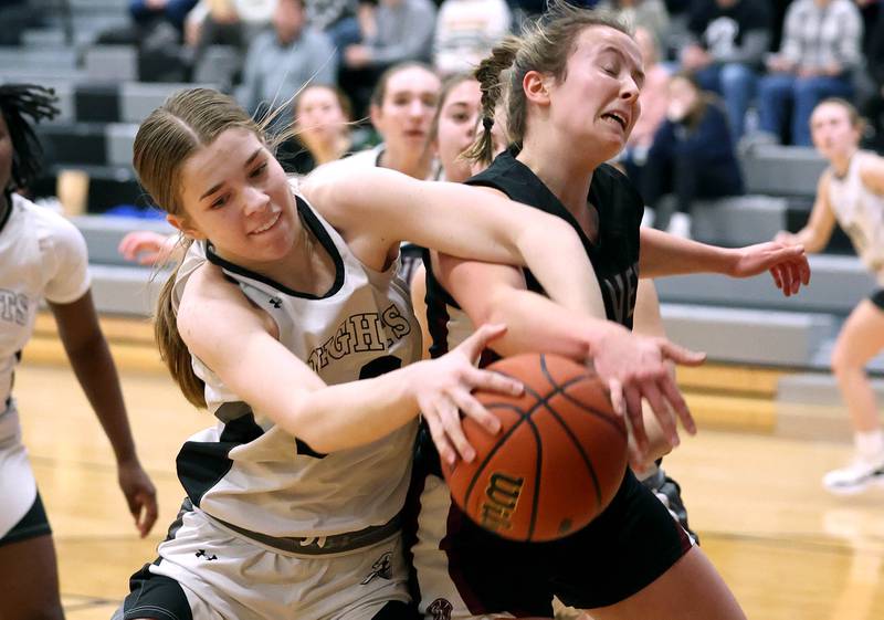 Kaneland's Sam Kerry and Prairie Ridge's Zoe Nanos fight for a loose ball Thursday, Feb 15, 2024, during their Class 3A regional final game at Kaneland High School in Maple Park.