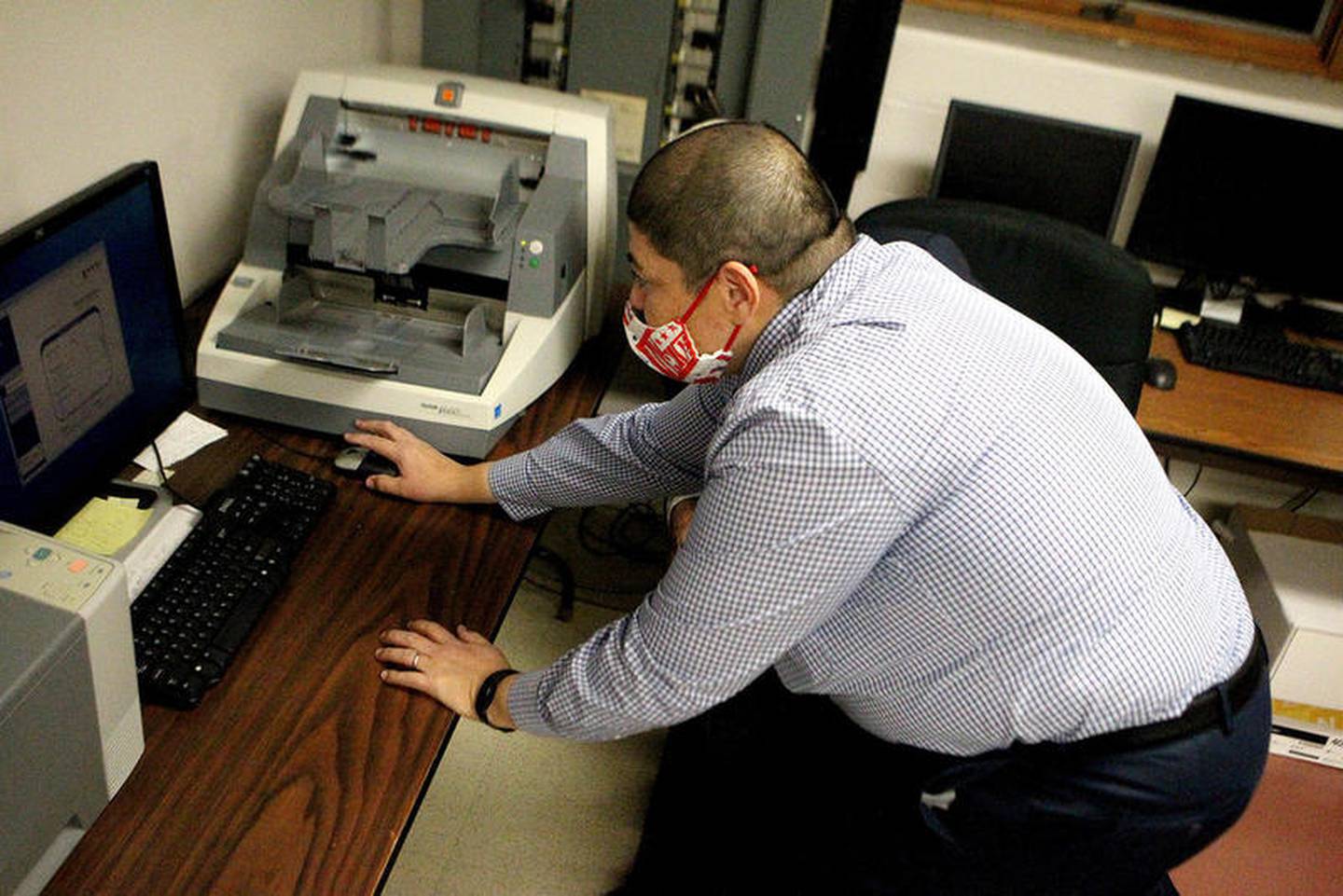 Raymond Esquivel, Kane County director of elections, pushes the start button for the tabulations of early voting and vote by mail ballots to begin at 7 p.m. after polls closed on Nov. 3 at the Kane County Clerk office in Geneva.