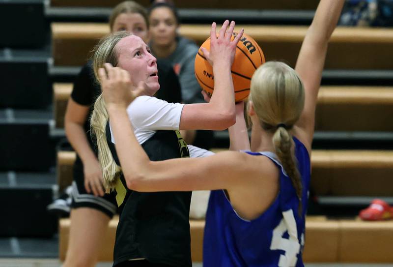 Sycamore’s Sadie Lang goes to the basket against Geneva’s Emma Peterson Thursday, June 12, 2025, in the Geneva High School Varsity Summer League.