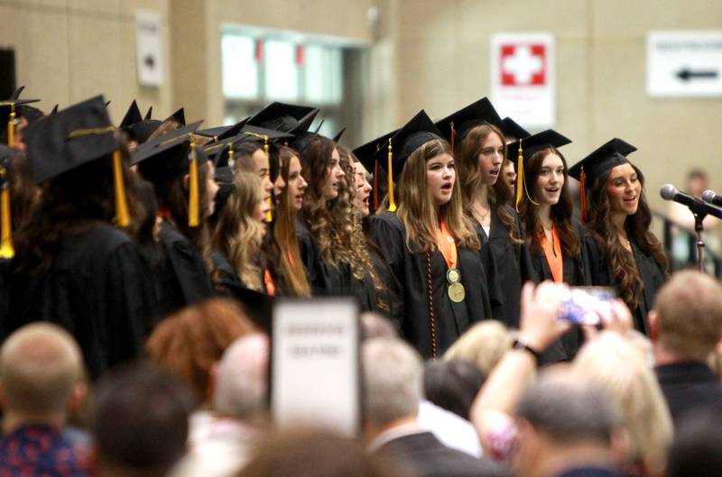Members of the Wheaton Warrenville South Senior Singers perform during the school’s commencement ceremony on Saturday, May 24, 2025 at the College of DuPage in Glen Ellyn.