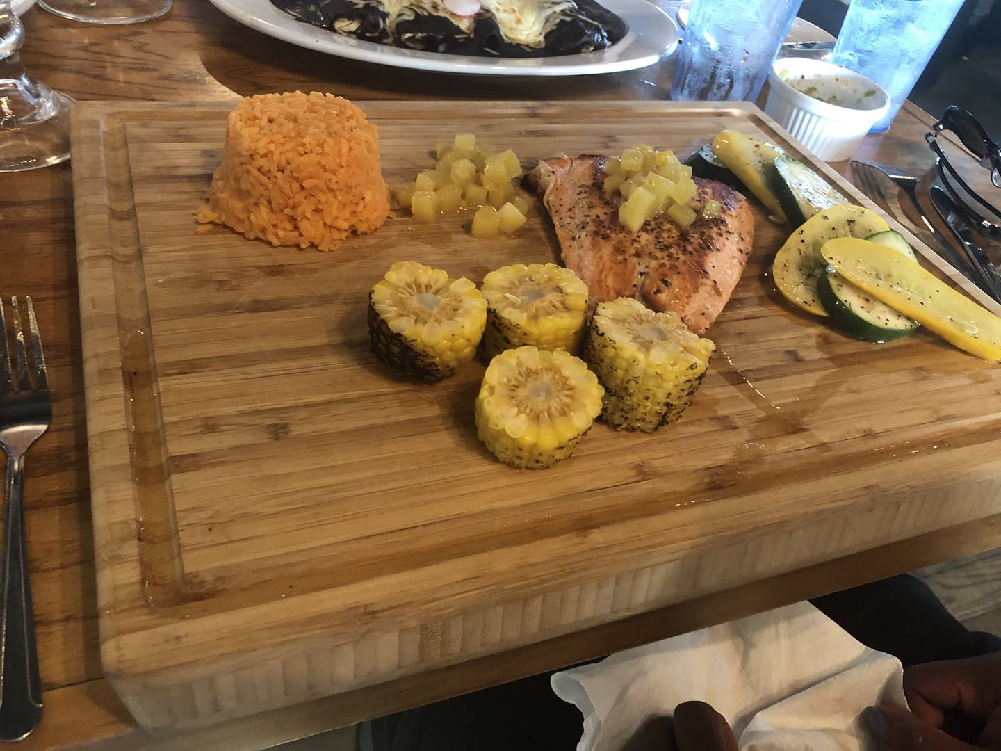 The salmon with pineapple served on a cutting board at El Diablo Cantina, Carpentersville, on June 20, 2022.