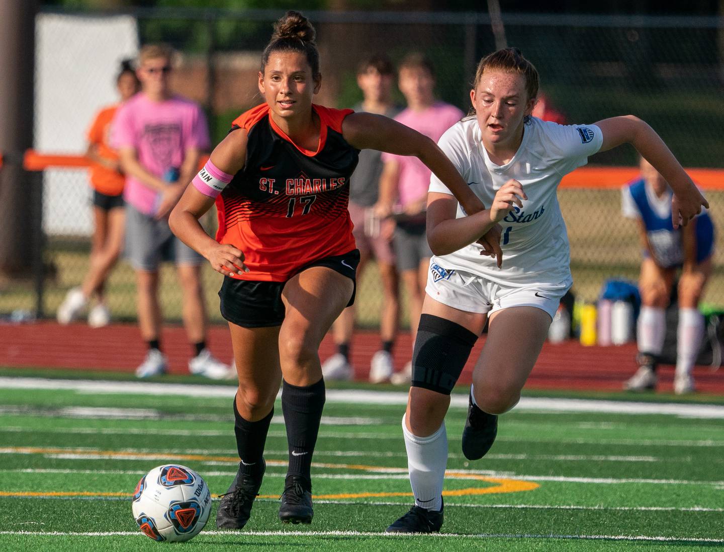 St.Charles East's Hannah Miller (17) moves the ball up the field against St.Charles North's Abigail Vichich (21) during a Class 3A girls soccer sectional final in St.Charles on Friday, June 11, 2021.