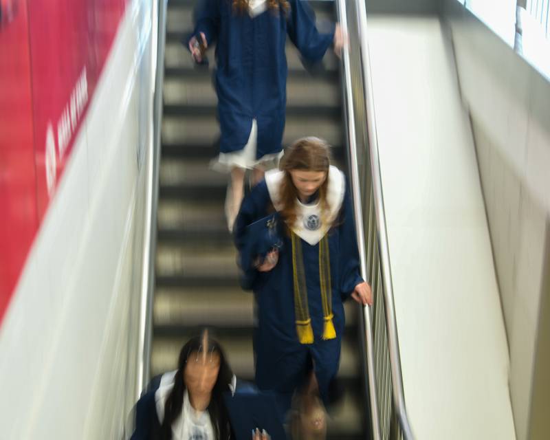 Oswego East graduates make their way inside the Convocation Center in Dekalb on Saturday May 17, 2025, to line up before the start of the commencement ceremony.
