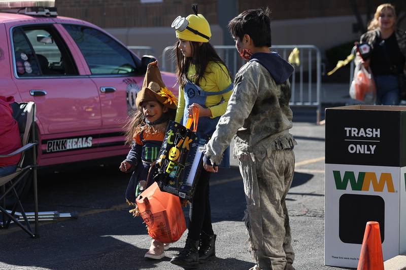 A group of kids collect candy at the Joliet Police Department Trunk-Or-Treat event on Saturday, Oct. 26, 2024 in Joliet.