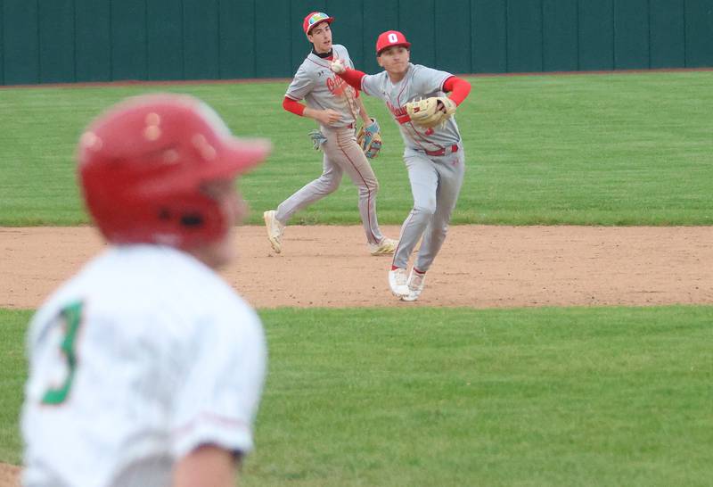 Ottawa's Rory Moore throws to first base as L-P's Braylin Bond runs to the bag on Thursday, April 30, 2026 at Huby Sarver Field in the L-P Athletic Complex in La Salle.