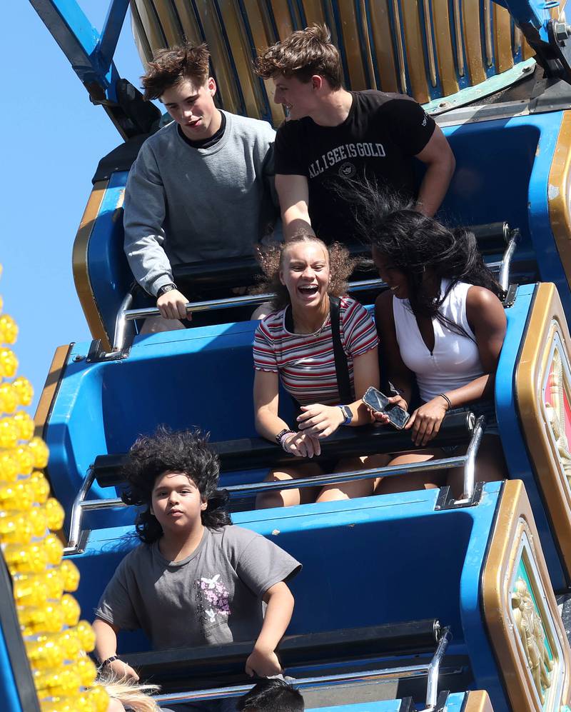 Visitors enjoy one of the rides in the carnival Friday, Aug. 22, 2025, during the first day of Corn Fest in downtown DeKalb.
