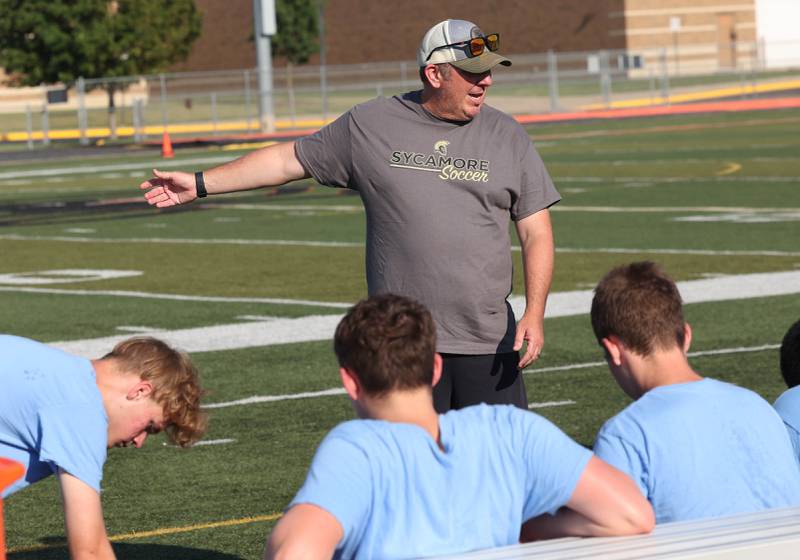 Sycamore boys soccer head coach Kevin Bickley talks to his team Monday, July 14, 2025, before a summer boys soccer friendly at DeKalb High School.