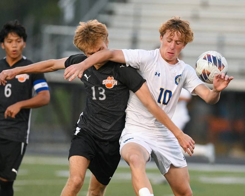 Wheaton Warrenville South's Noah Giannasi (13) and Wheaton North's Rocco Johnson (10) battle for the ball during the game on Thursday Sept. 11, 2025, held at Wheaton Warrenville South.