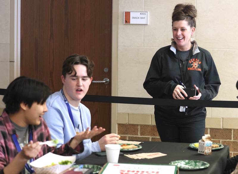 Donna Larson, principal at DeKalb High School, talks to student of the quarter winner Alisha Cambari Saka (left) and her friends Thursday, Jan. 11, 2024, at DeKalb High School. The students of the quarter are chosen by their teachers based on a criteria that includes attendance, academic standing, and attitude. They are rewarded with a pizza party during their lunch period.