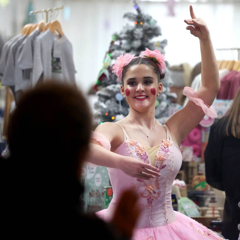 Veronica Young, 15, from Genoa, along with others from the Beth Fowler School of Dance perform in the window of Adventure Sprouts for visitors Friday, Nov. 22, 2024, during Moonlight Magic in downtown Sycamore.