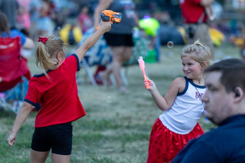 (left to right) Judith Torbik and Layla Kay play with bubbles on Saturday, July 5, 2025 at Carey Memorial Park in Utica.