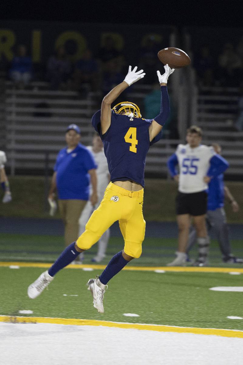 Sterling’s Quincy Maas has a pass tick off his hands in the open field against Quincy Friday, Oct. 17, 2025.