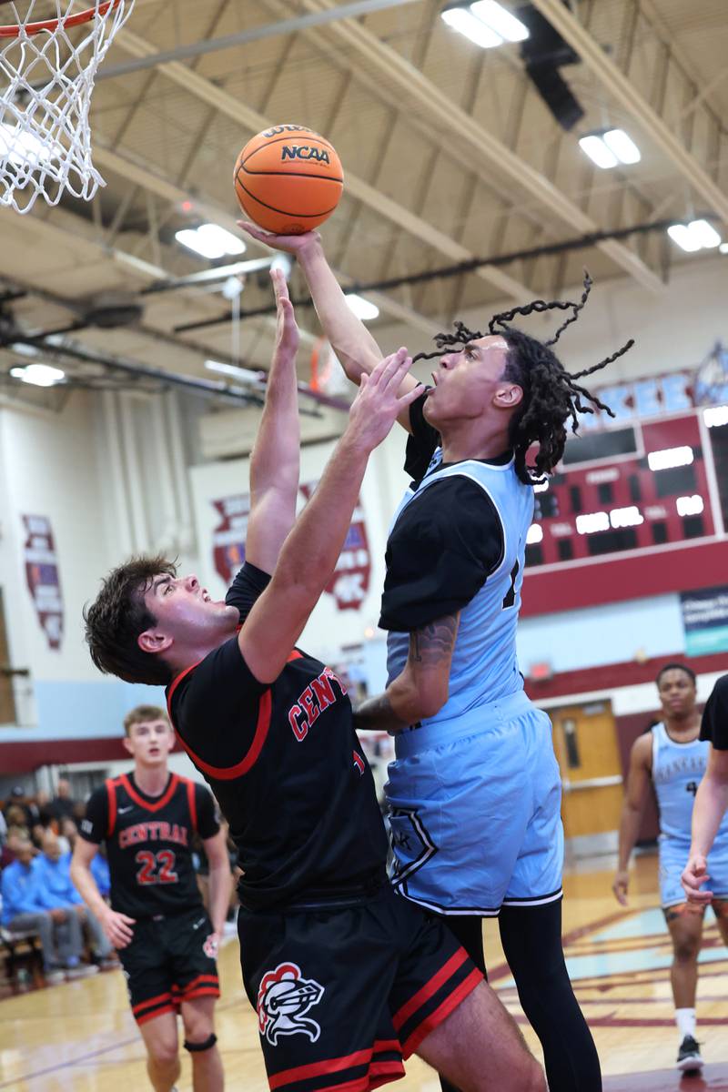 Kankakee's Lincoln Williams shoots under pressure from Lincoln-Way Central's Drew Woodburn during the Kays' 54-50 victory over Lincoln-Way Central in the 75th Kankakee Holiday Tournament maroon bracket championship on Sunday, Dec. 28, 2025.