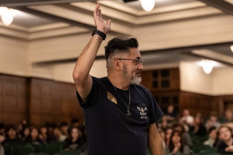 Joliet School District 86 Board President, Jesse Smith, who is a Navy veteran, waves to the audience during the Veterans Day Assembly at Joliet Central High School on Nov. 7, 2025.