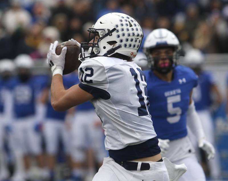 Cary-Grove's Landon Barnett catches a touchdown pass in front of Geneva's Dylan Reyes during an IHSA Class 6A semifinal football game on Saturday, Nov. 23, 2024, at Geneva High School.