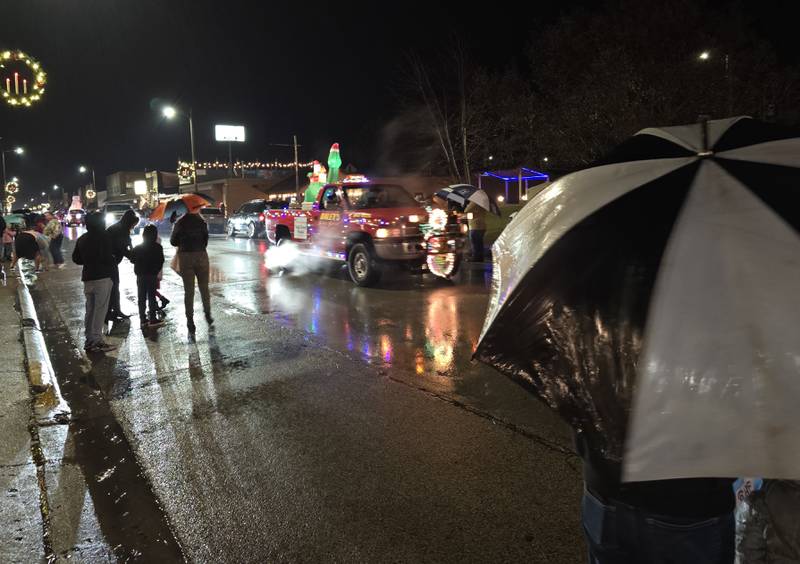 Parade goers sheltered under umbrellas as it rained throughout the Winter Wonderland parade Saturday, Dec. 14, 2024, in Oglesby.