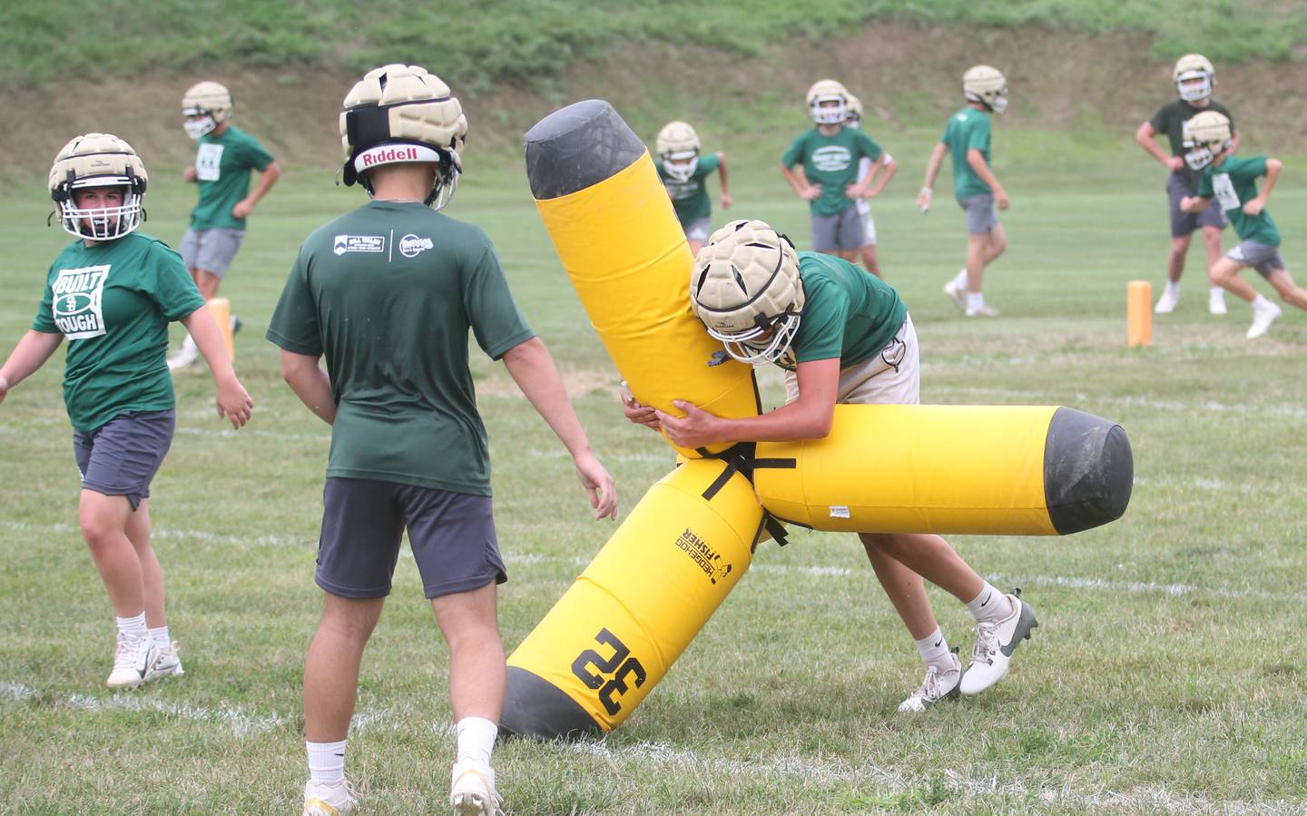 St. Bede players flip over the Hedgehog four-way dummy, a new edition this year during the first day of football practice on Monday, Aug. 12, 2024 at St. Bede Academy.